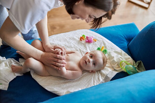 "A parent gently massaging natural oil onto a baby's skin.