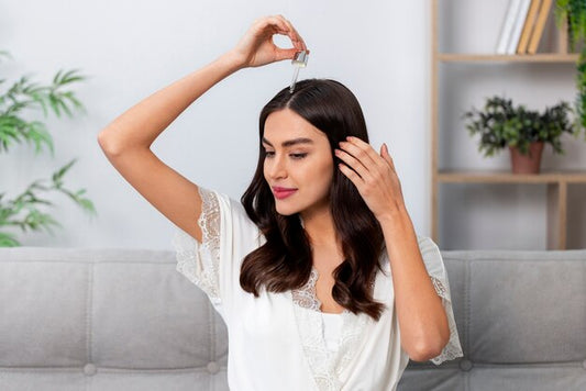 Woman applying natural oil to her hair